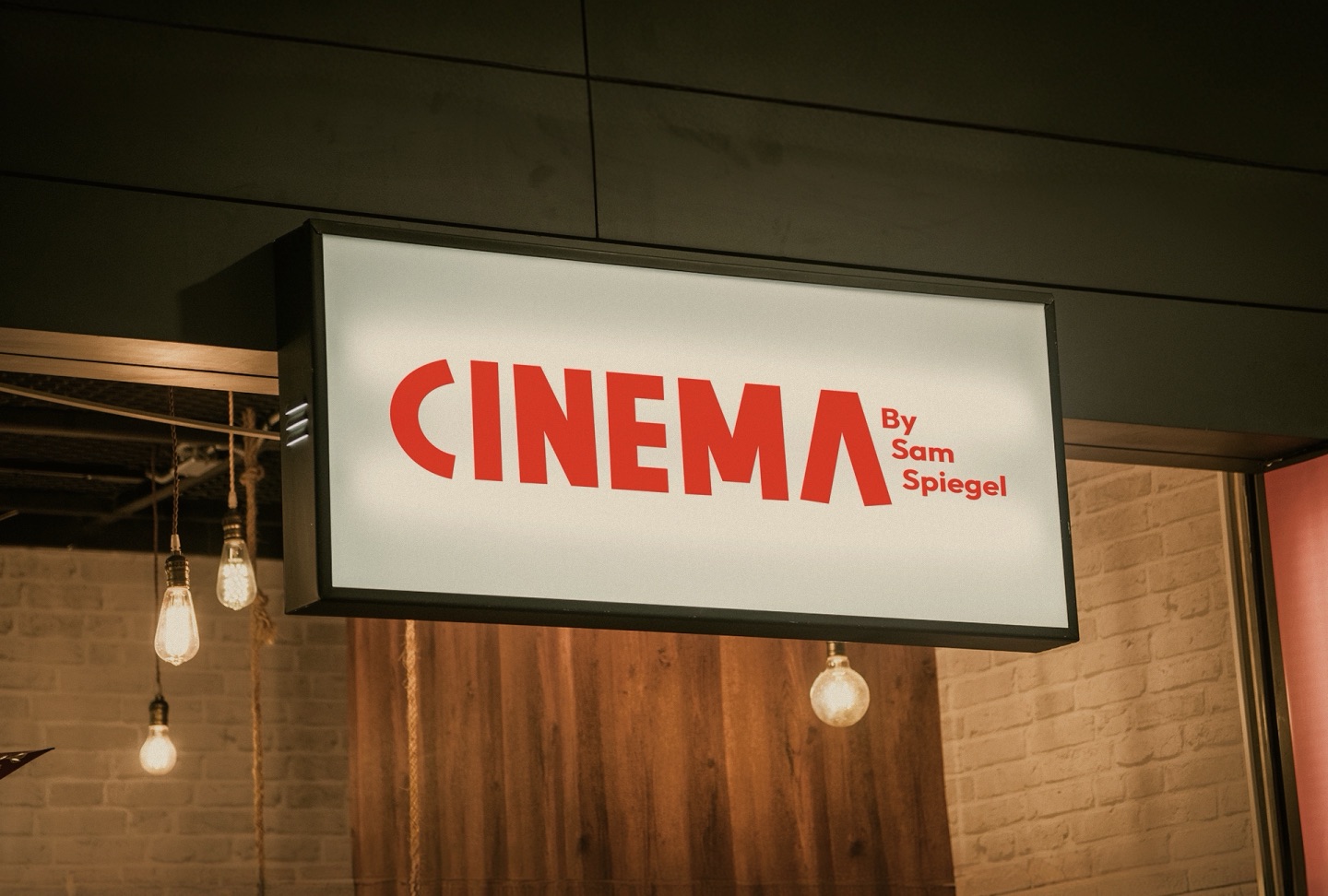 Illuminated CINEMA by Sam Spiegel sign above the bar