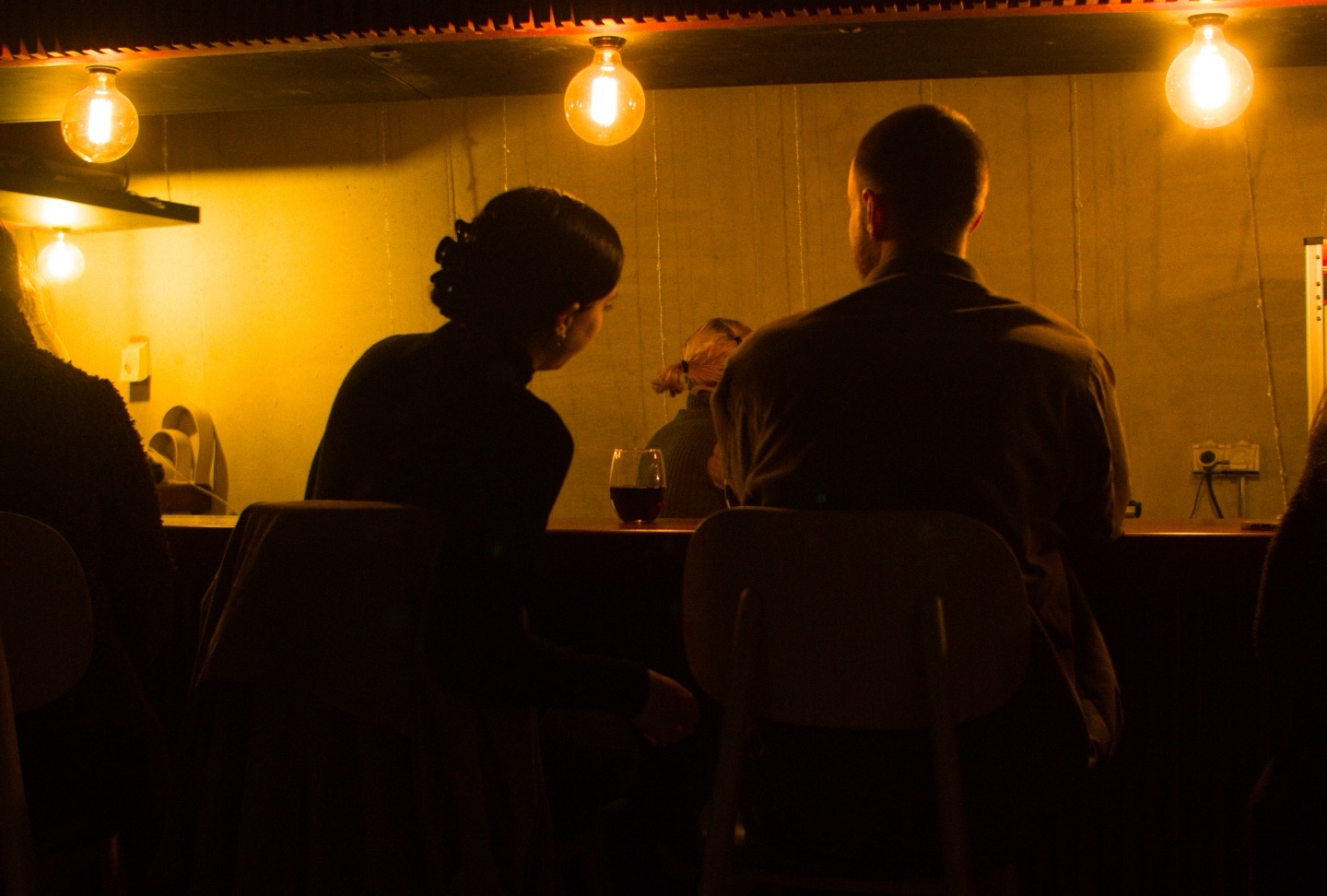 Guests at the cinema bar in warm light