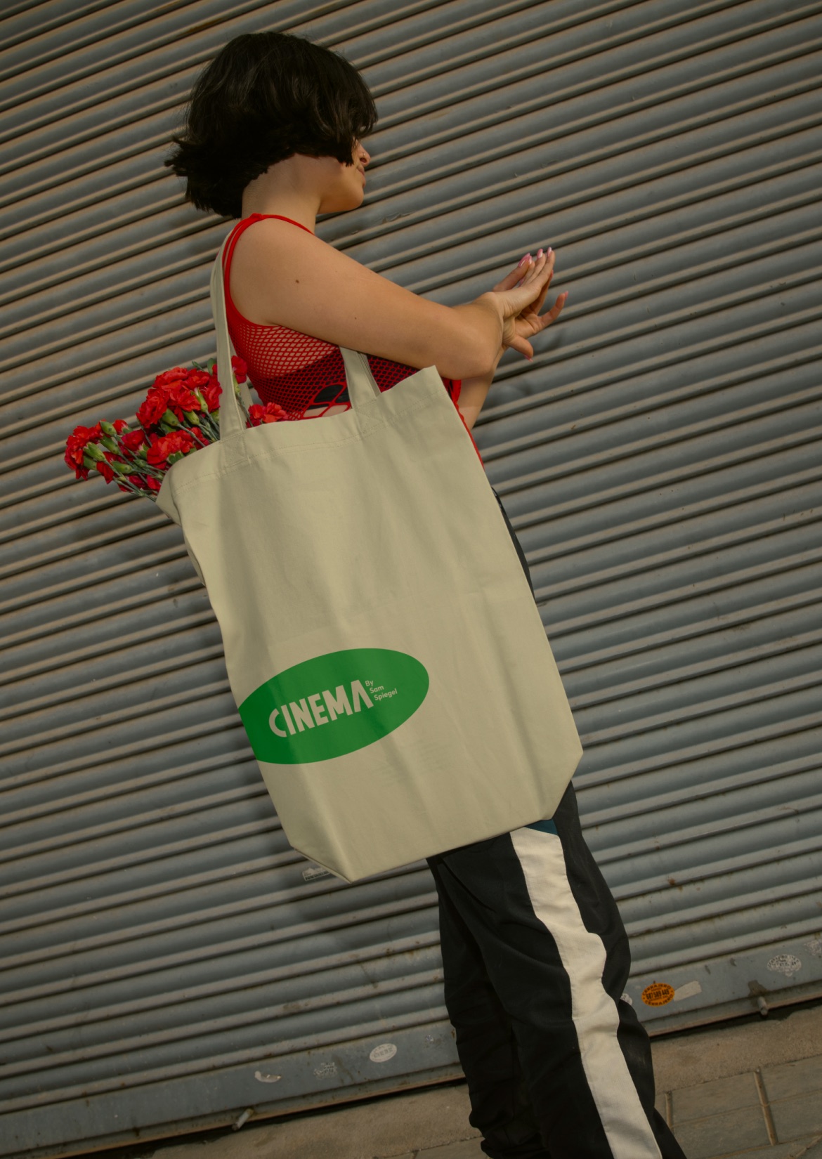 CINEMA tote bag filled with red carnations