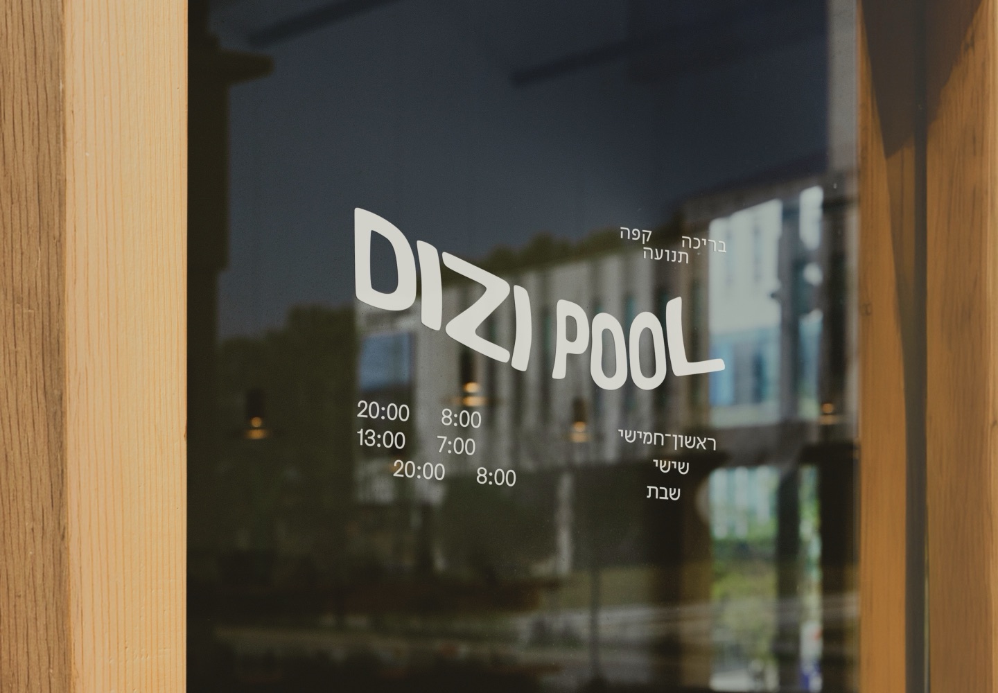Dizi Pool logo and opening hours on a glass door