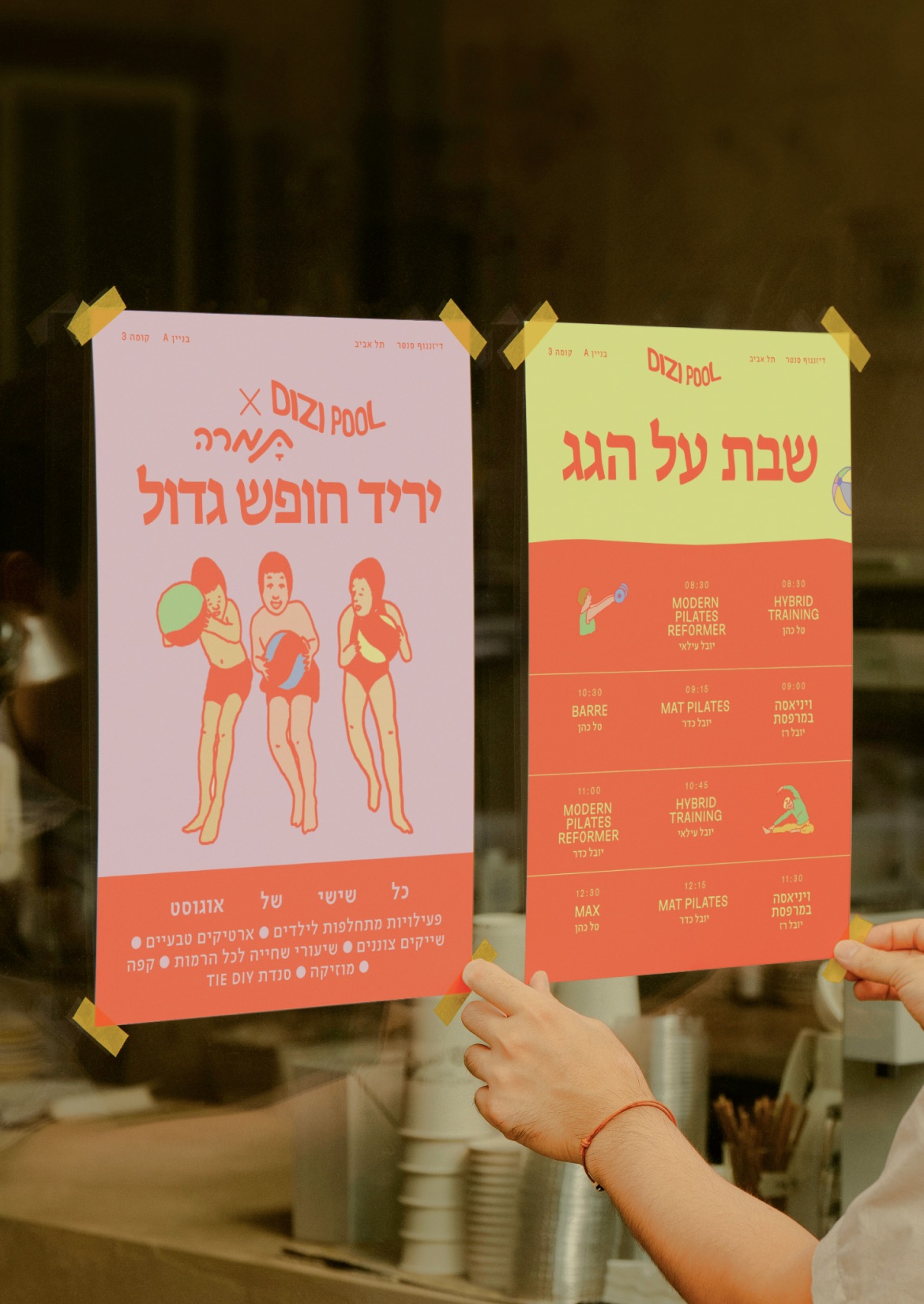 Dizi Pool posters taped to a café window: a summer fair and a rooftop class schedule